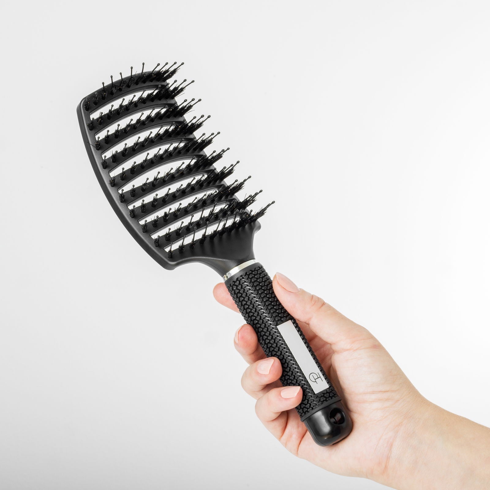 Curved paddle hårbørste